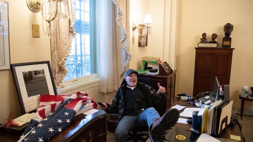 Arkansas Trump supporter, Richard Bennett, shown with feet up on Pelosi's desk, arrested. -Getty