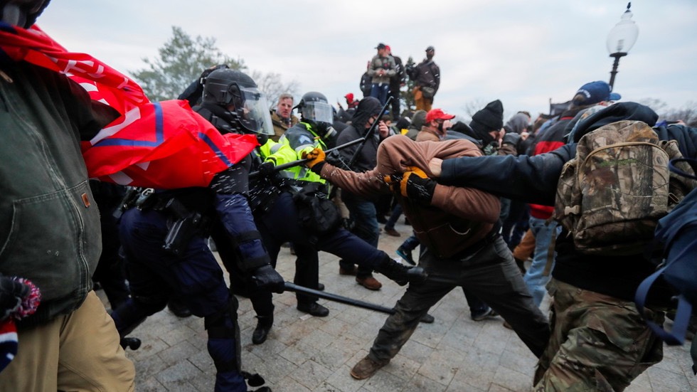Law enforcement officers scuffle with protestors attempting to enter US Capitol. -Jim Bourg:Reuters
