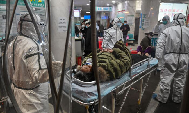 Medical staff arrive with another patient at Wuhan Red Cross Hospital Jan 25, 2020 -Hector Retamal :AFP Getty