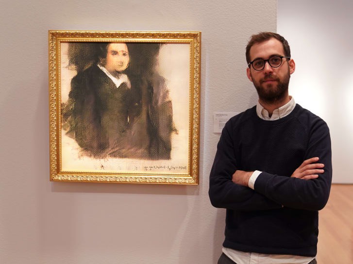 Obvious co-founder Pierre Fautrel stands beside "Edmond de Belamy" before it hits the auction block at Christie's in New York. Credit- TIMOTHY A. CLARY:AFP:AFP:Getty Images