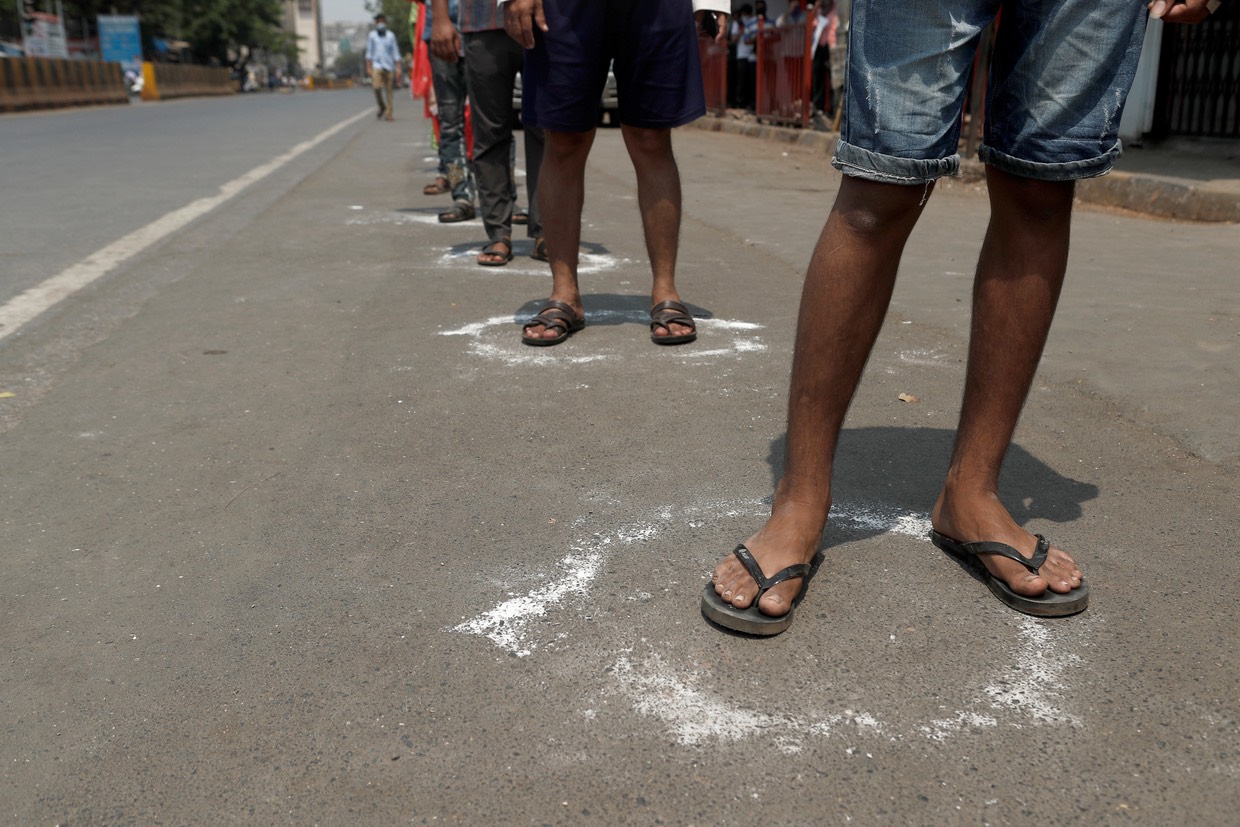 People line up in circles drawn with chalk to maintain safe distance in Mumbai, India, March 25, 2020. ©  REUTERS:Francis Mascarenhas